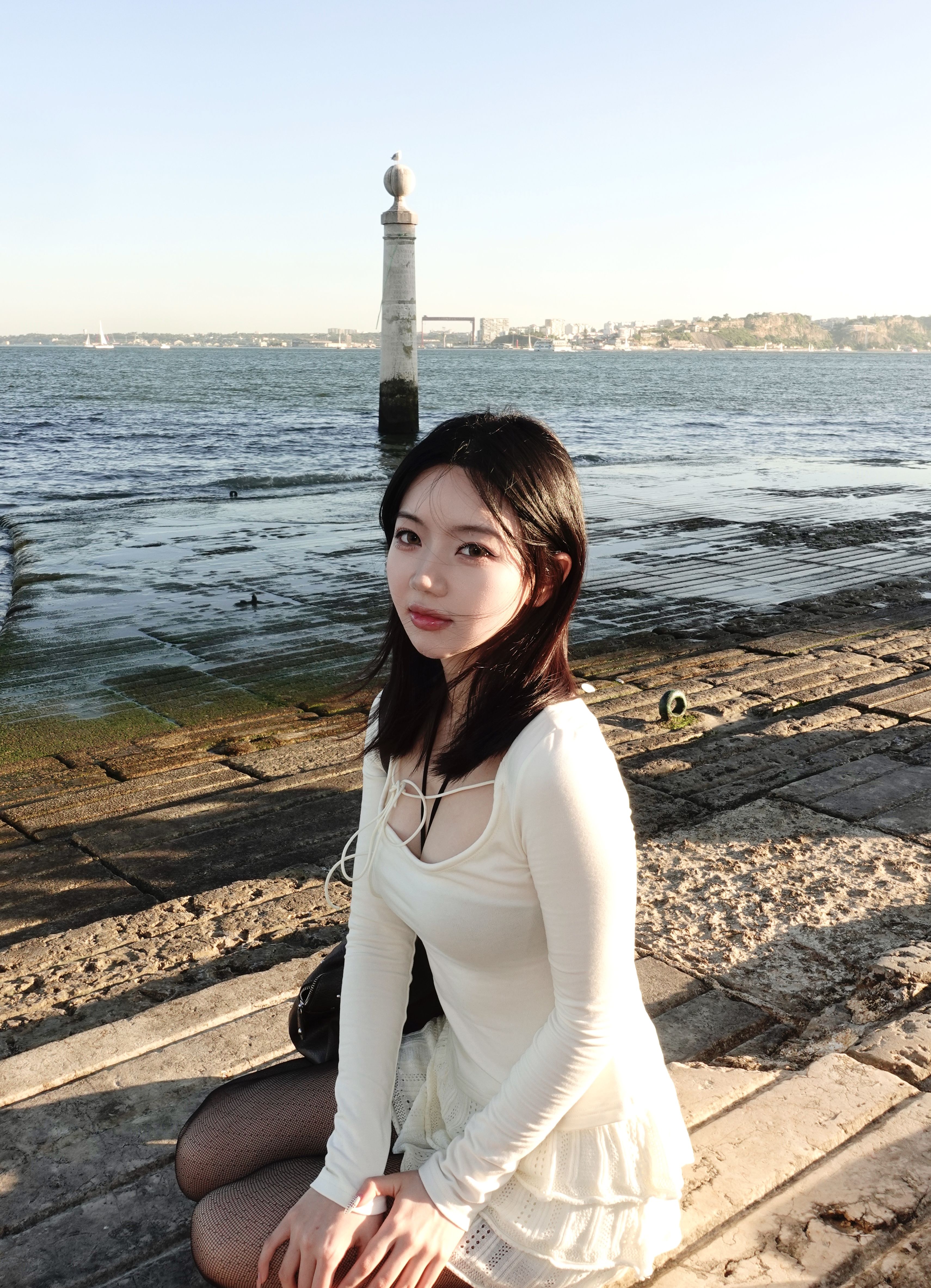 Mengyuan Zhu sitting by the waterfront